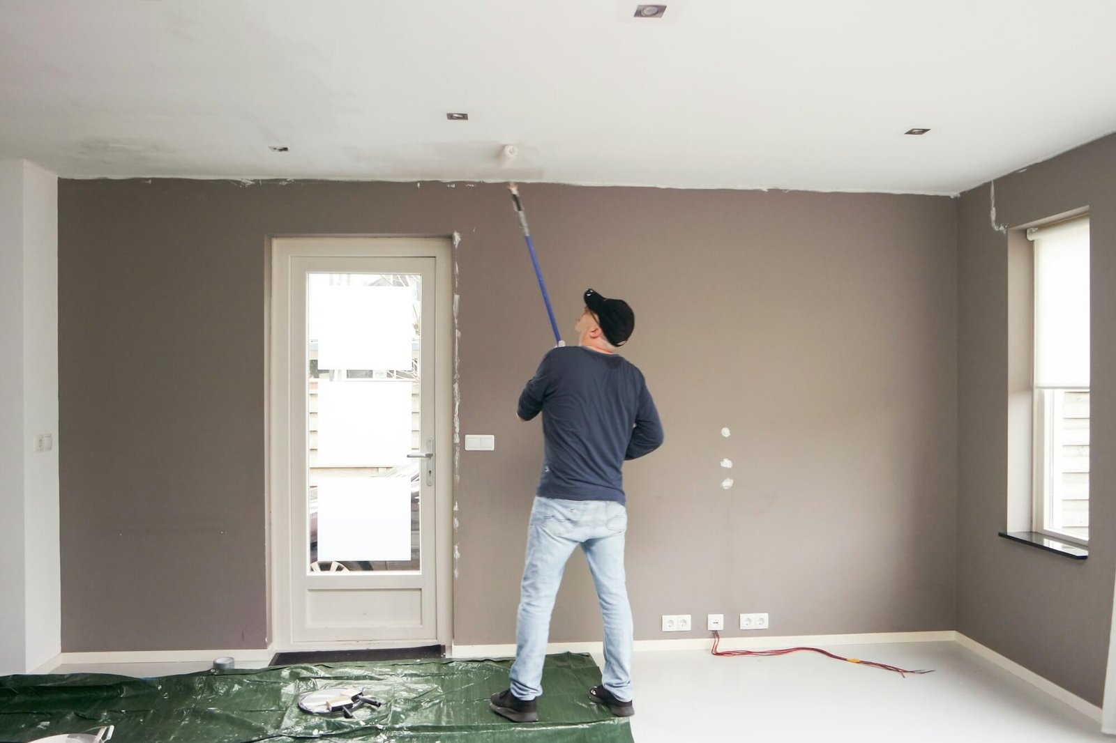 man-full-length-painting-the-ceiling-home-renovation-.jpg